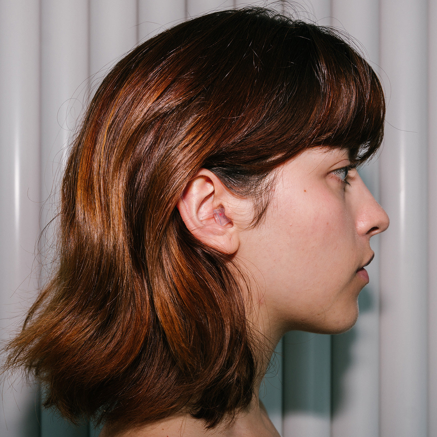 Sideprofile of girl wearing Earasers Earplugs 